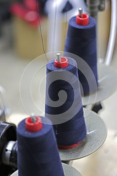 Blue thread on red bobbins