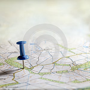 Blue thumbtack marking and showing destination location point on map background with copy space