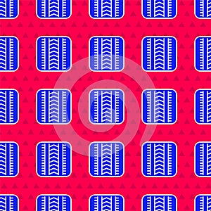 Blue Tire track icon isolated seamless pattern on red background. Vector