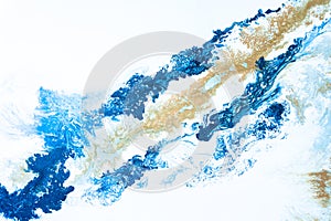 Blue tone and gold beige background graphic from acrylic pour art showing liquid formations