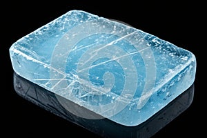Blue-toned ice block with cracks isolated