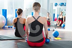 Blue toning ball in women pilates class rear view photo