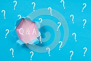 Blue torn paper with question mark revealing Q&A word photo