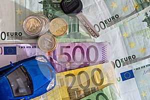blue toy car with key, euro bills