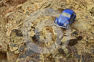 Blue toy car on mountain.