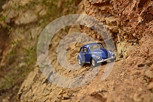 Blue toy car on mountain.