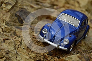 Blue toy car on mountain.