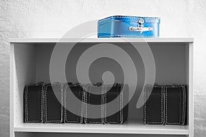 Blue toy case with black and white cases on the shelf background