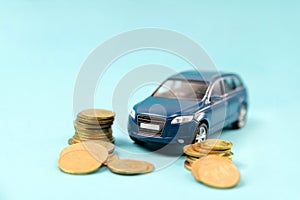 Blue toy suv car park on stack golden coins. Saving, Financial and Installment payment concept