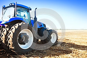 Blue tractor in a field