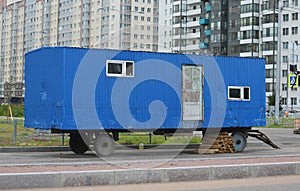 Blue trailer-a shed for workers on the street