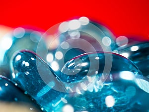 Blue translucent glass stones with white highlights on a red background