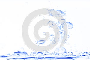 Blue transparent aqua water splash with bubbles on white clean background abstract