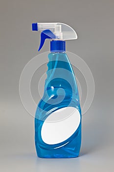 Blue transparent detergent spray bottle Isolated on gray