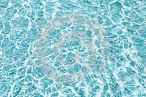 Blue transparent water with flecks of sunshine
