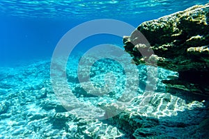 Blue transparent water and pitfalls of the Aegean Sea, seascape. Underwater photography, selective focus.