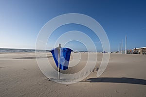 Blue trash cans dustbin on an empty beach