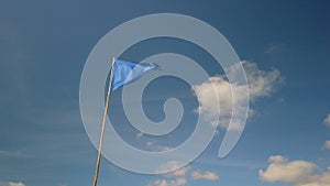 Blue triangle flag against blue sky in France