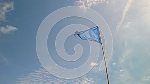 Blue triangle flag against blue sky in France