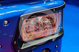 Blue truck headlight. Detail of a lorry close up. Truck electrical equipment. Road safety