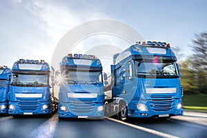 Blue trucks speeding in line composing