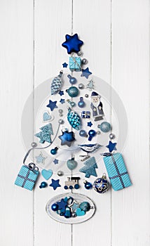 Blue and turquoise christmas tree of small miniatures on white w