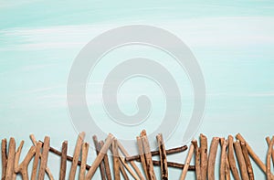 Blue or turquoise oceanic background with a fence of driftwood f