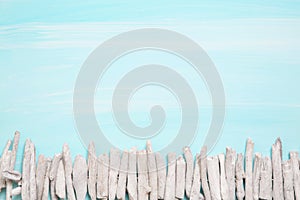 Blue or turquoise oceanic background with a fence of driftwood f photo