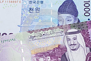 A blue won note from South Korea with a five riyal note from Saudi Arabia photo
