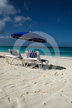 Blue umbrella and chairs on caribbean Anguilla beach