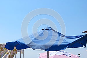 Blue umbrella in a sunny beach day photo