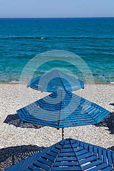 Blue umbrellas on a beach