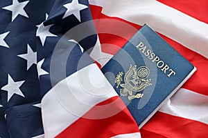 Blue United States of America passport on national flag background close up