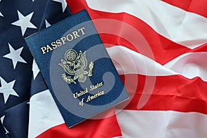 Blue United States of America passport on national flag background close up