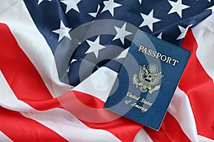 Blue United States of America passport on national flag background close up