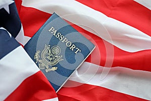 Blue United States of America passport on national flag background close up