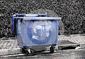 Blue urban tagged container. Degradation of public property.