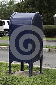blue us mailbox on sidewalk