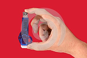 Blue USB Flash drive on hand with isolated red background