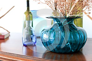 Blue vase with dried flowers on an old chest of drawers - Image