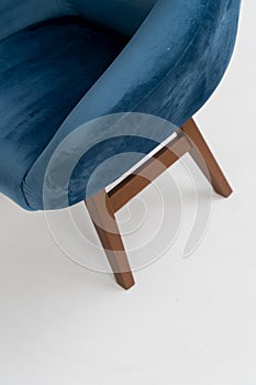 blue velor chair with wooden legs