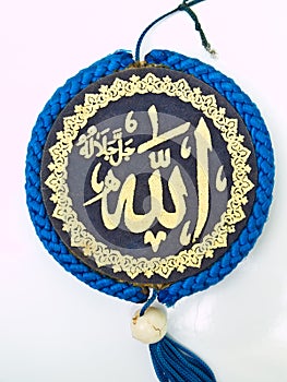 A blue velvet Allah pendent isolated on white