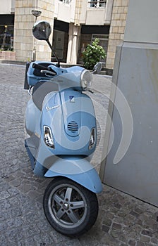 A blue Vespa motorcycle