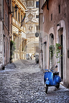 Blue Vespa in the old street of Rome photo