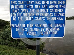 Blue veterans sanctuary sign about sacrifice and dignity and water