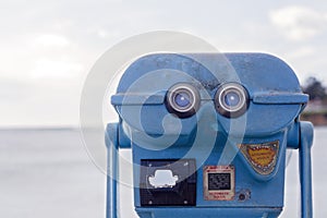 Blue Vintage Style Public Coin Operated Binoculars With View of Ocean