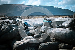 Blue vintage wooden boats on white beach of Caleta del Mojon Blanco. Sandy desert beach and rugged coastline. Orzola