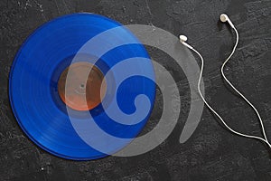 Blue Vinyl record on a black background. Retro style. Top view.