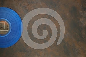 Blue Vinyl record on a rusty background. Retro style. Top view