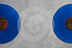 Blue Vinyl record on a stone background. Retro style. Top view.